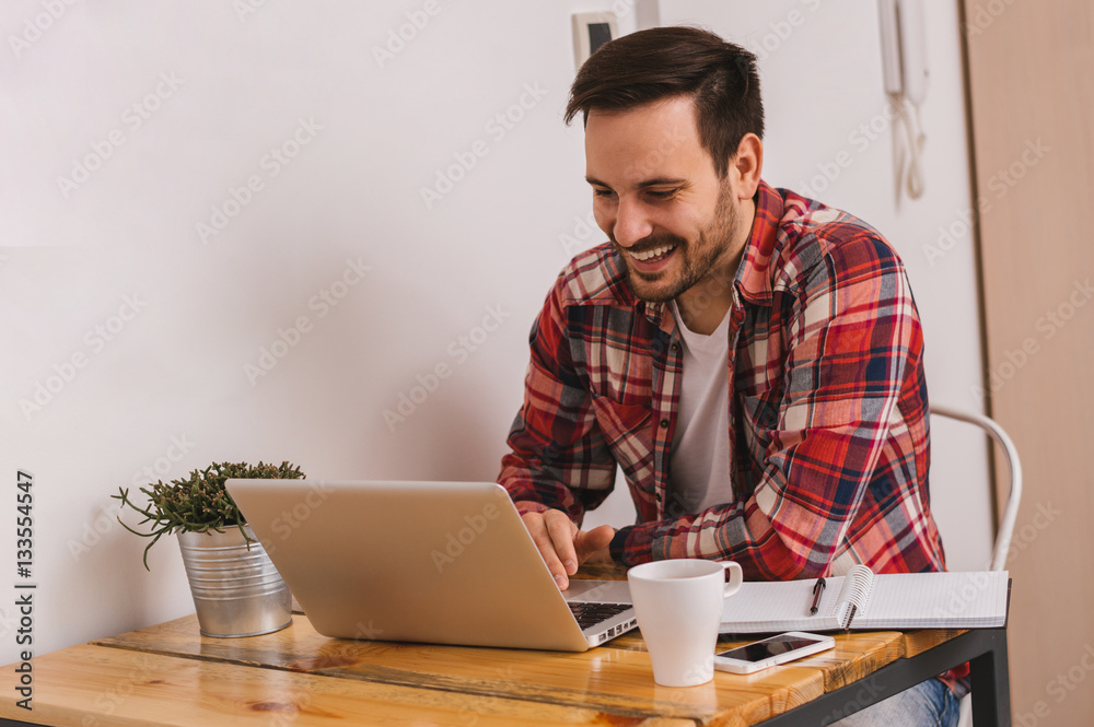 Man working on laptop computer from home