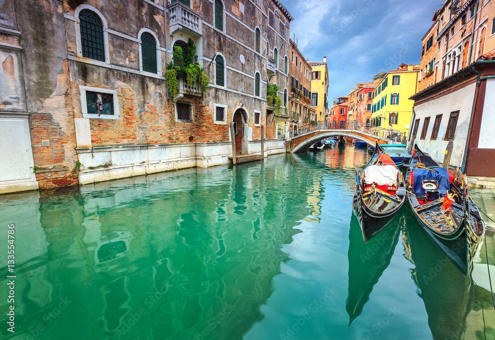 Spectacular narrow canal with gondolas in Venice, Italy, Europe