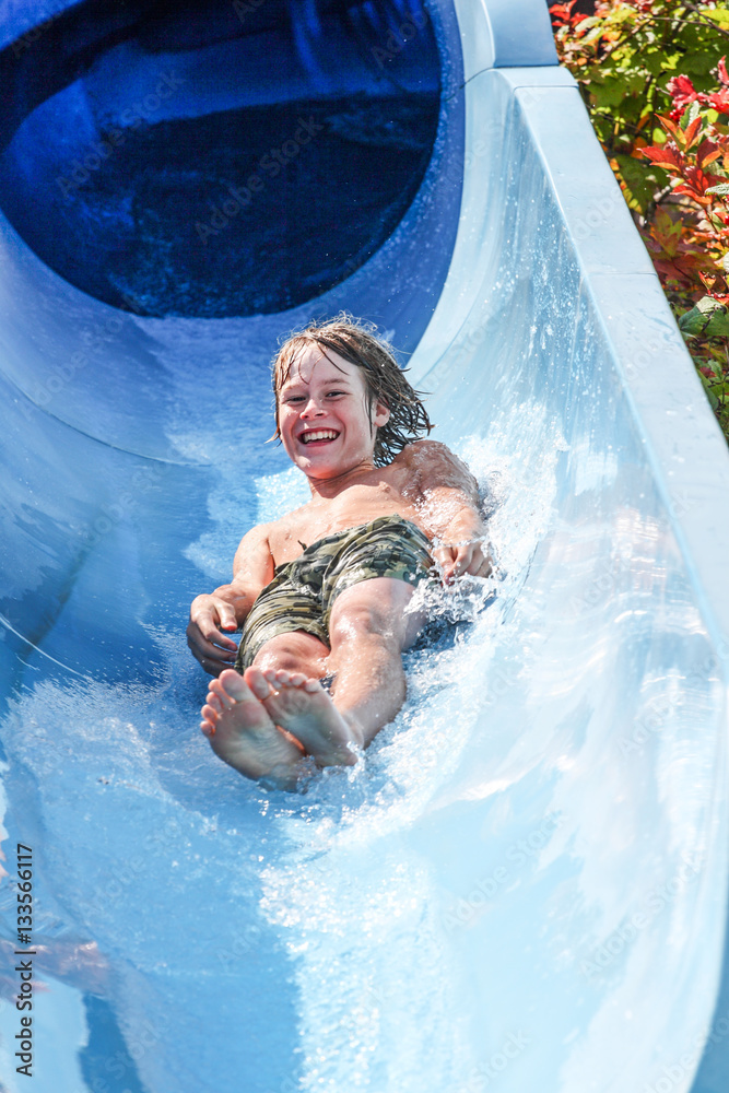 Boy on a tube going down a water slide