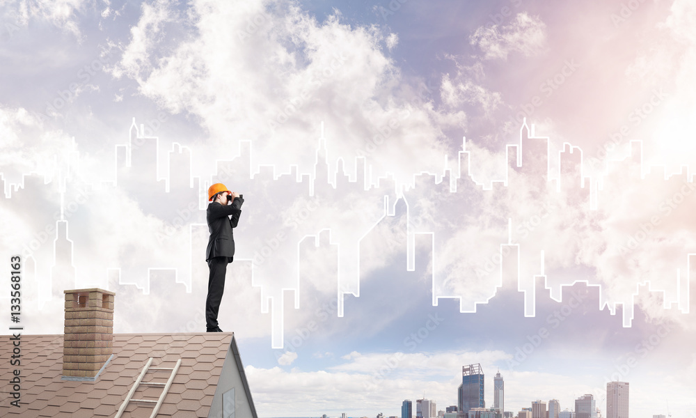 Engineer man standing on roof and looking in binoculars. Mixed media