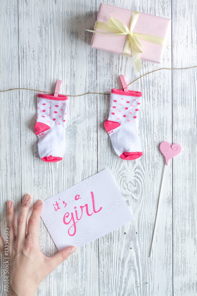 birth of girl - baby shower concept on wooden background