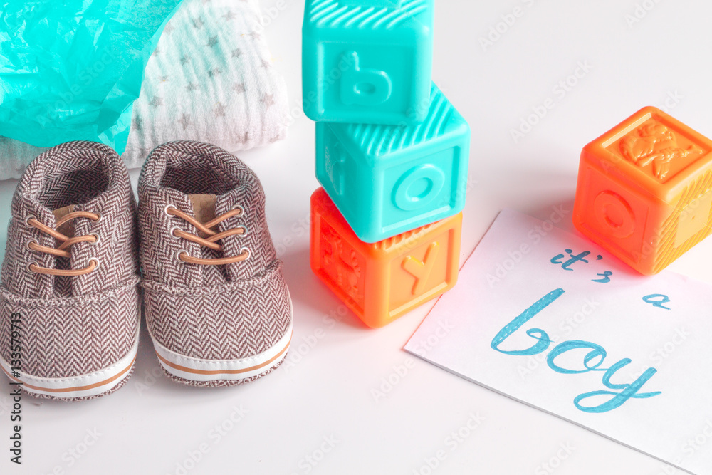 babys bootees and gift box on wooden background