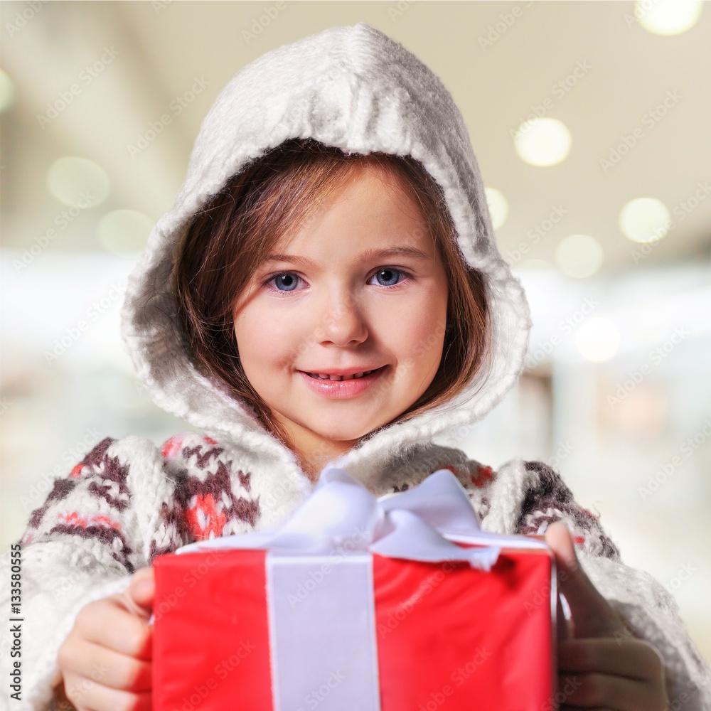 Child giving a christmas present.