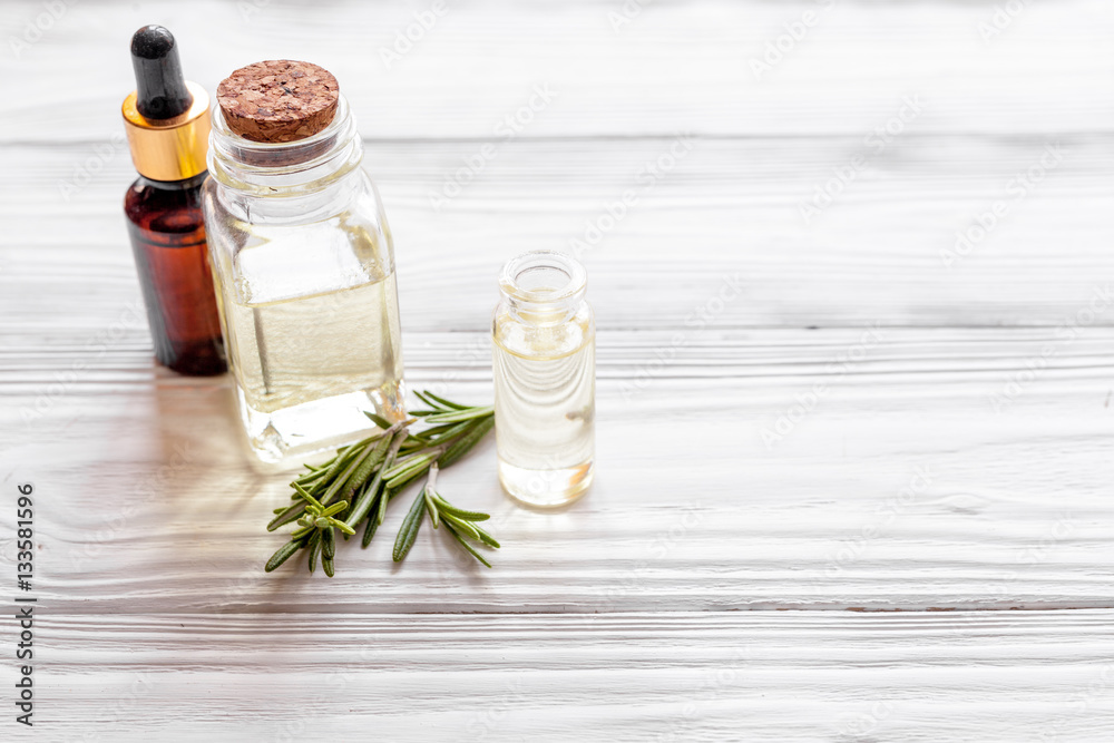 organic cosmetics with extracts of herbs rosemary on wooden background