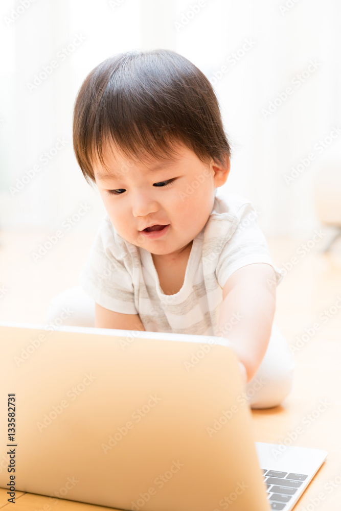 asian baby using laptop computer