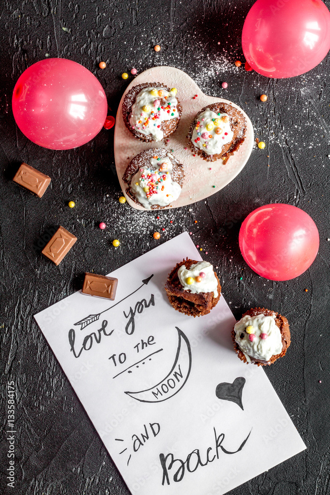 concept of Valentines Day cupcakes dark background top view