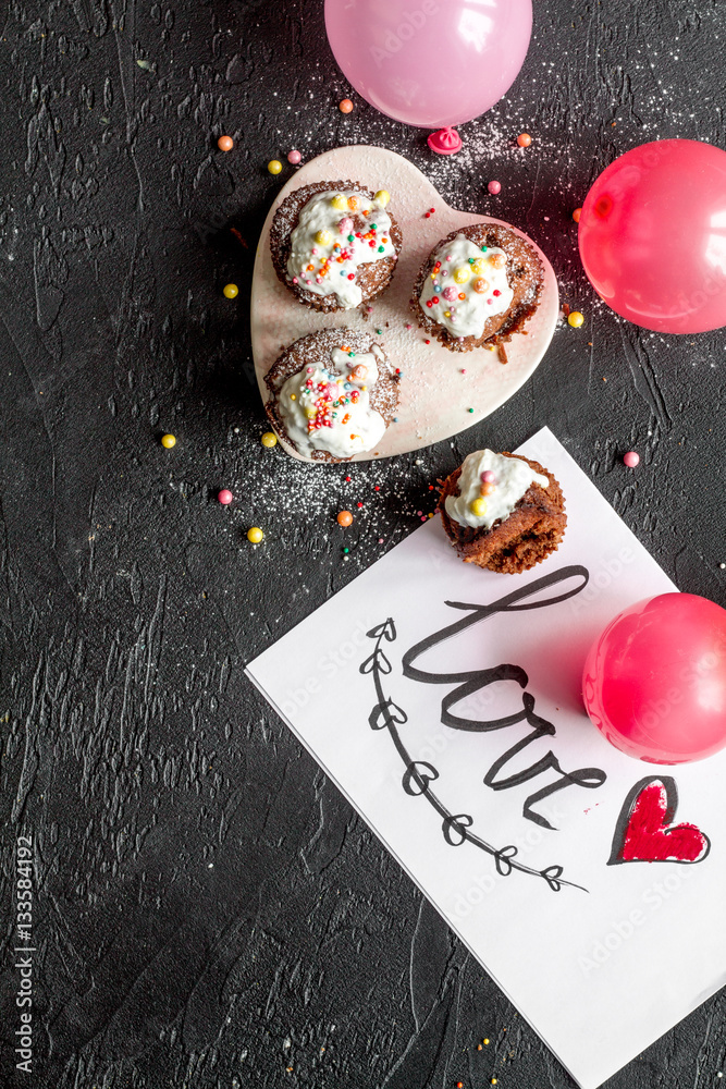 concept of Valentines Day cupcakes dark background top view