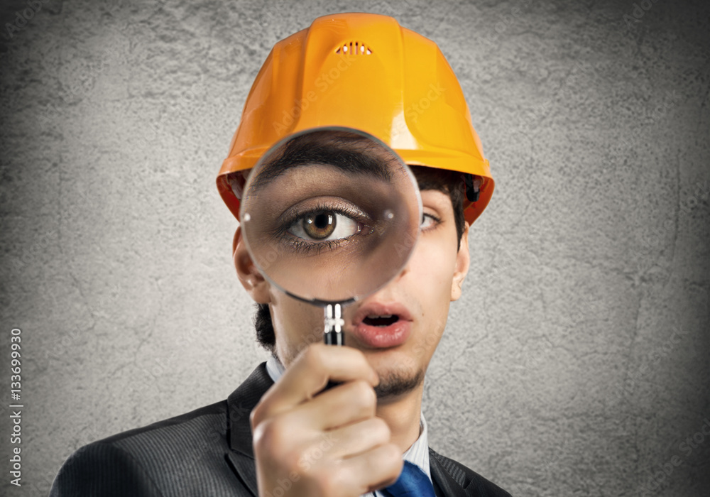 Construction man with magnifier