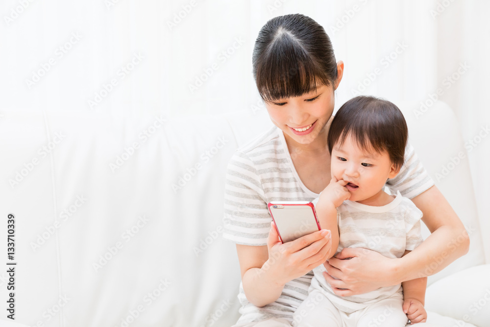 asian mother and baby using smart phone