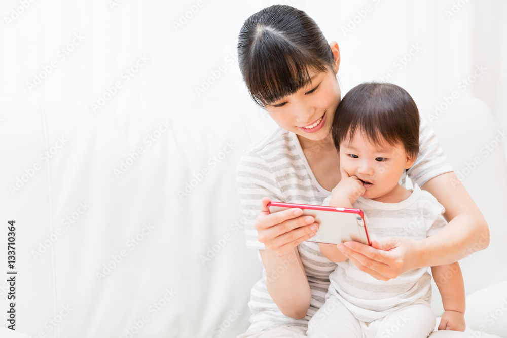 asian mother and baby using smart phone