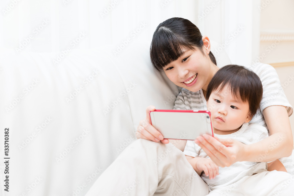 asian mother and baby using smart phone