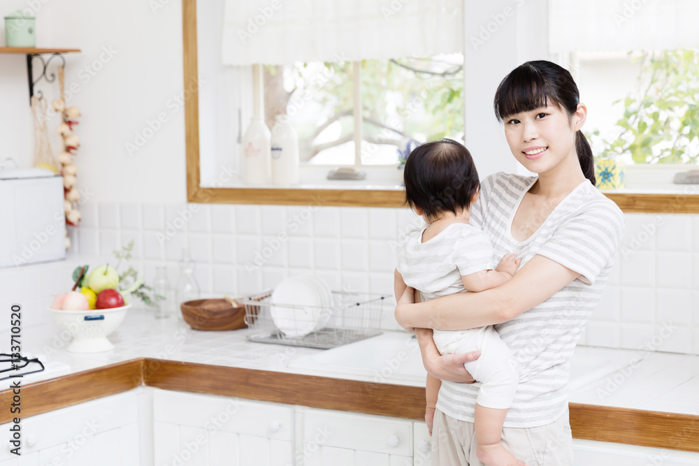 portrait of asian mother and baby in the kitchen