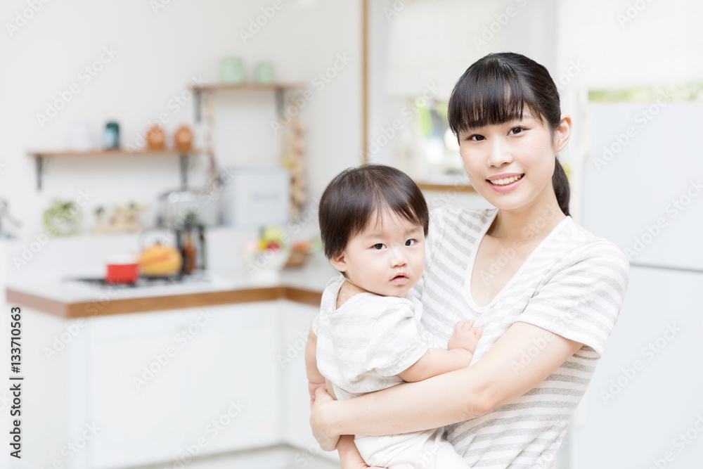 portrait of asian mother and baby in the kitchen