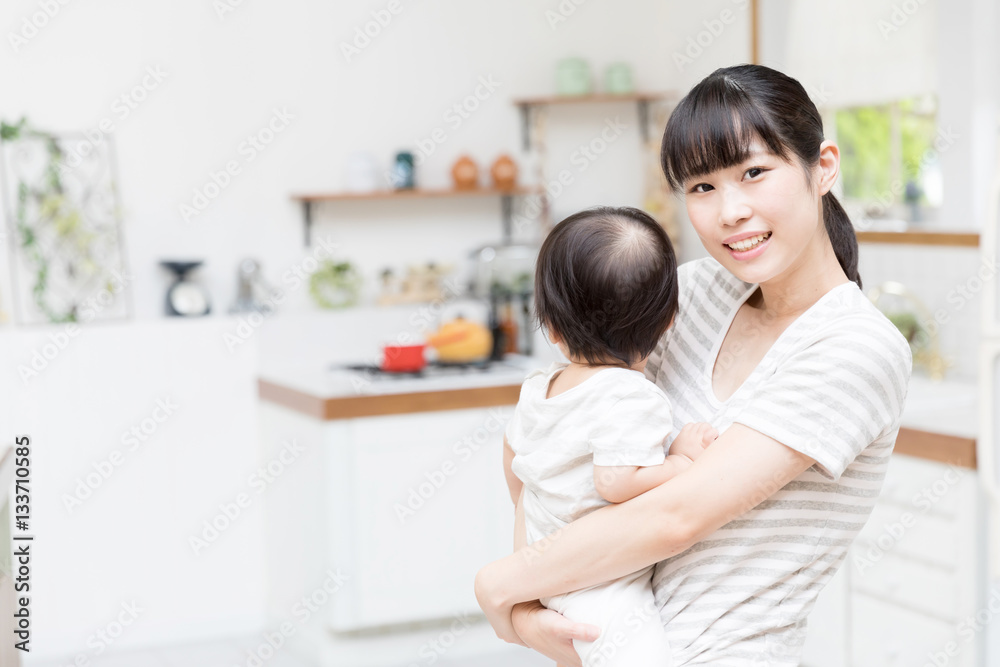 portrait of asian mother and baby in the kitchen