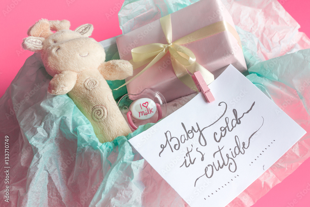 babys bootees and gift box on wooden background