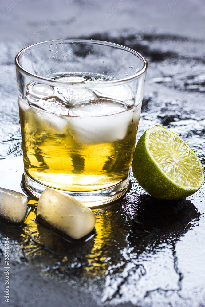 glass of whiskey on dark background