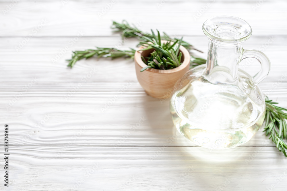 organic cosmetics with extracts of herbs rosemary on wooden background