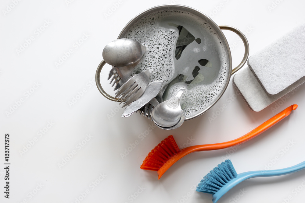 concept of washing dishes on white background top view