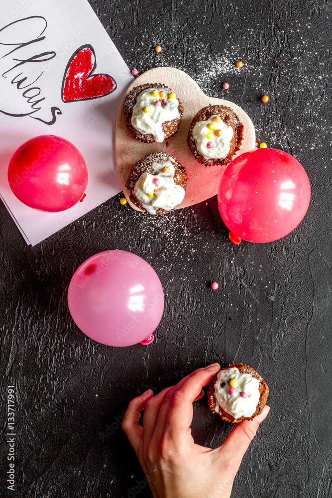 concept of Valentines Day cupcakes dark background top view