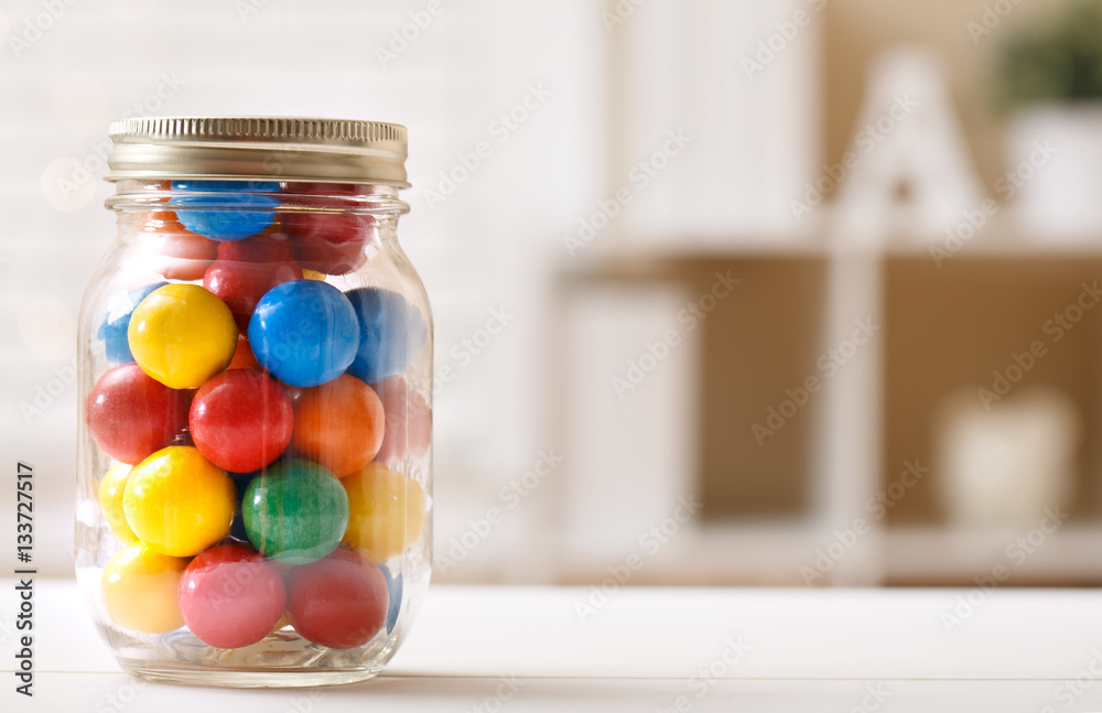 Colorful candies in a glass jar