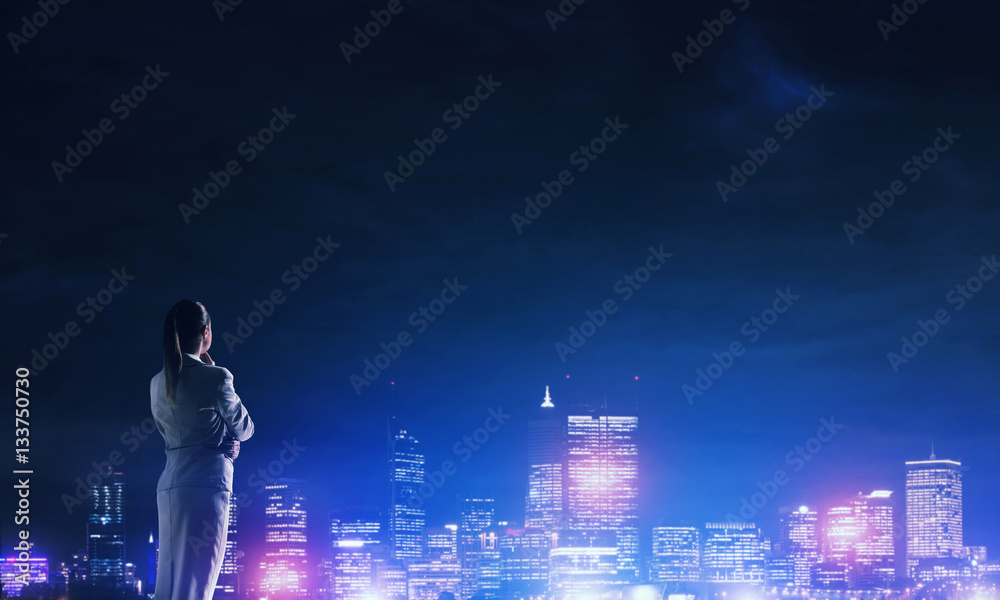 Woman looking at night city