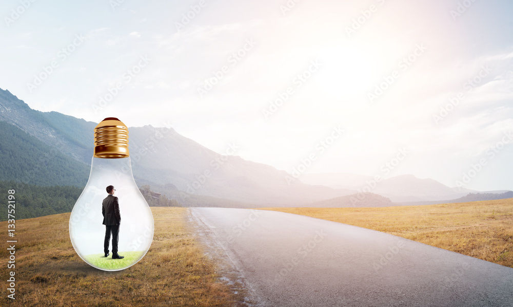 Businessman inside light bulb