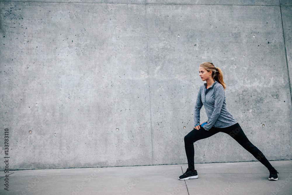 Fit young woman doing stretching workout