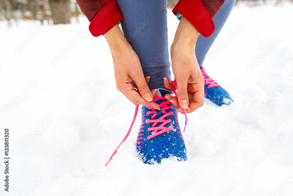 Running shoes - woman tying shoe laces