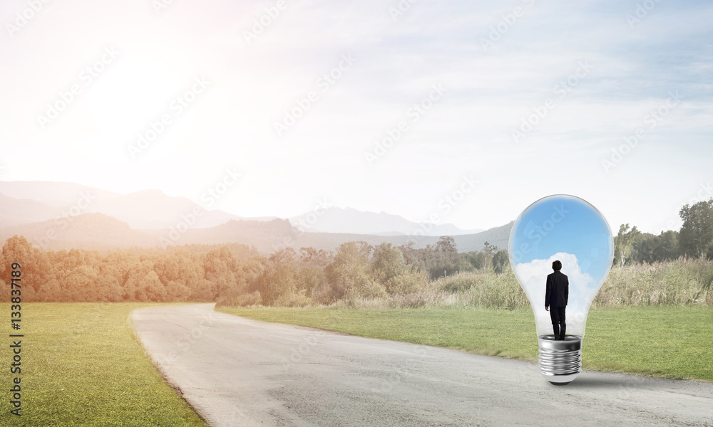 Businessman inside light bulb