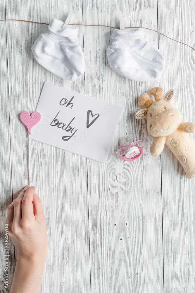 birth of child - baby shower concept on wooden background