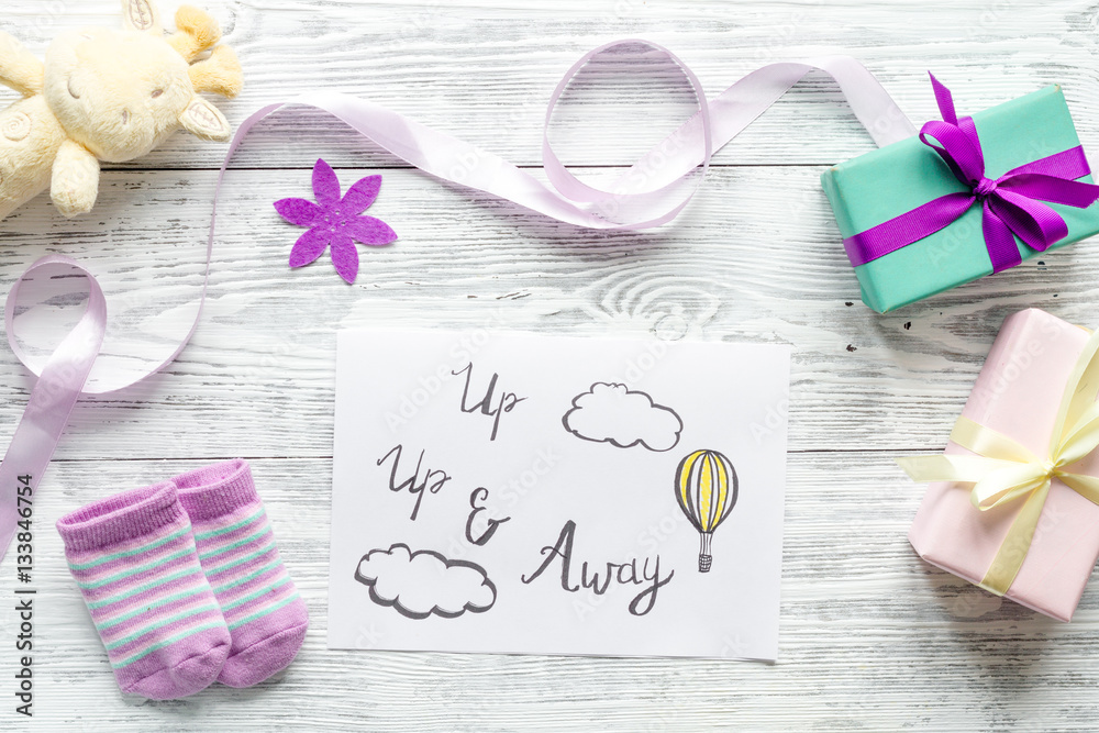 babys bootees and gift box on wooden background