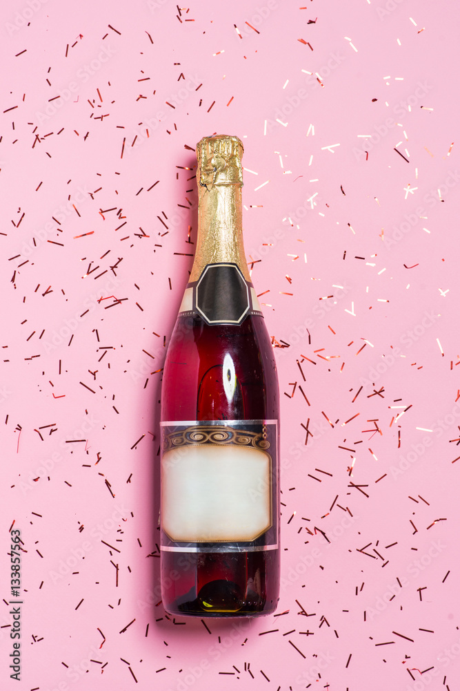 Flat lay of Celebration. Champagne bottle with colorful party st