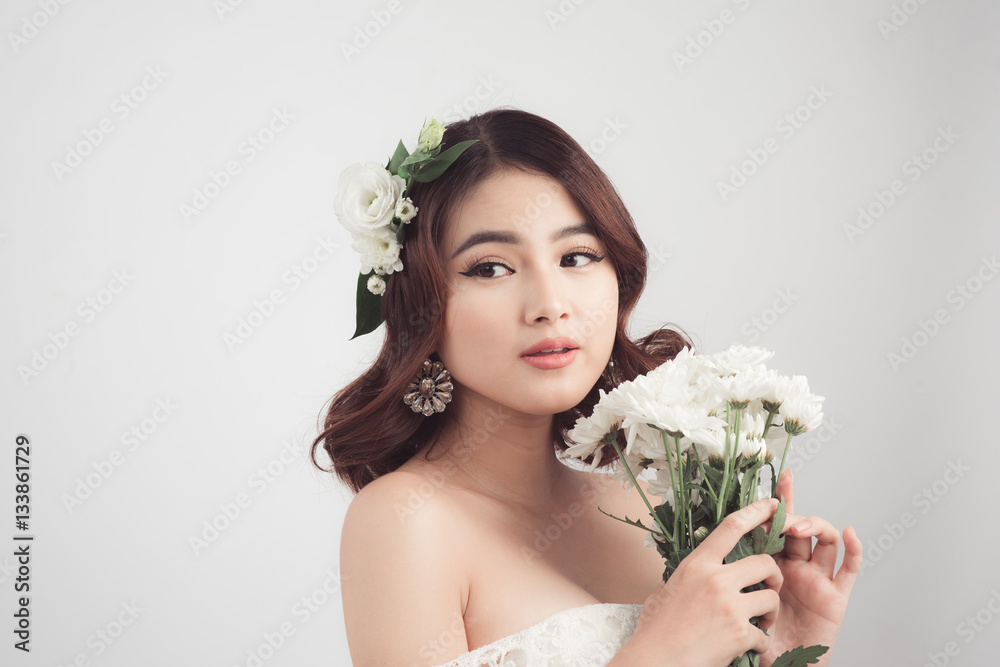 Beautiful asian woman bride on grey background. Closeup portrait