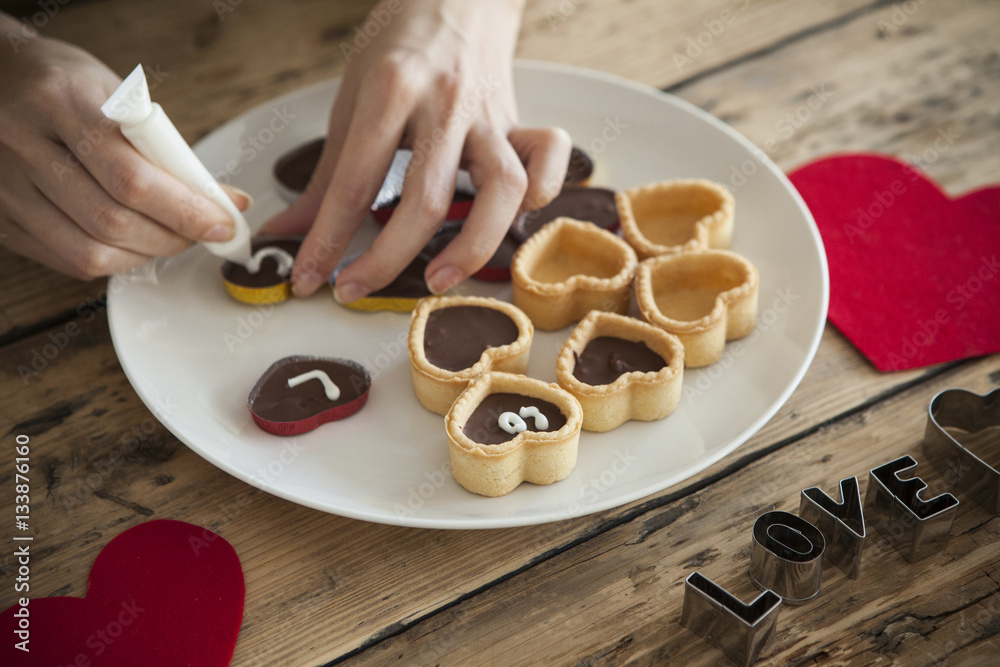 Women are writing letters in chocolate