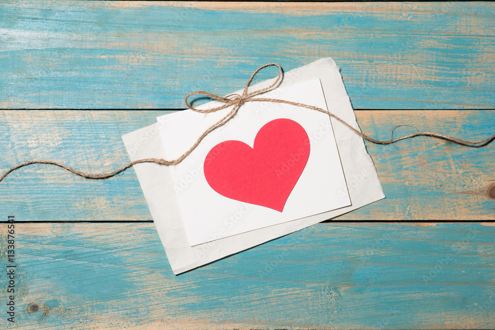 Valentines Day greeting card over wooden background. Top view w