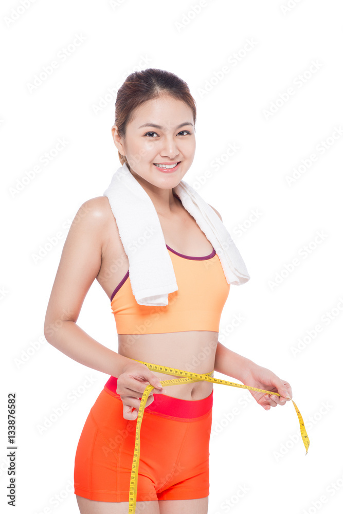 Portrait of fitness young asian woman with towel holding measuring tape