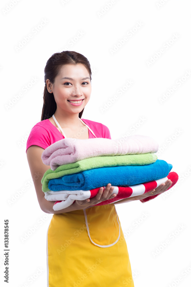 A portrait of a young asian woman holding clothes