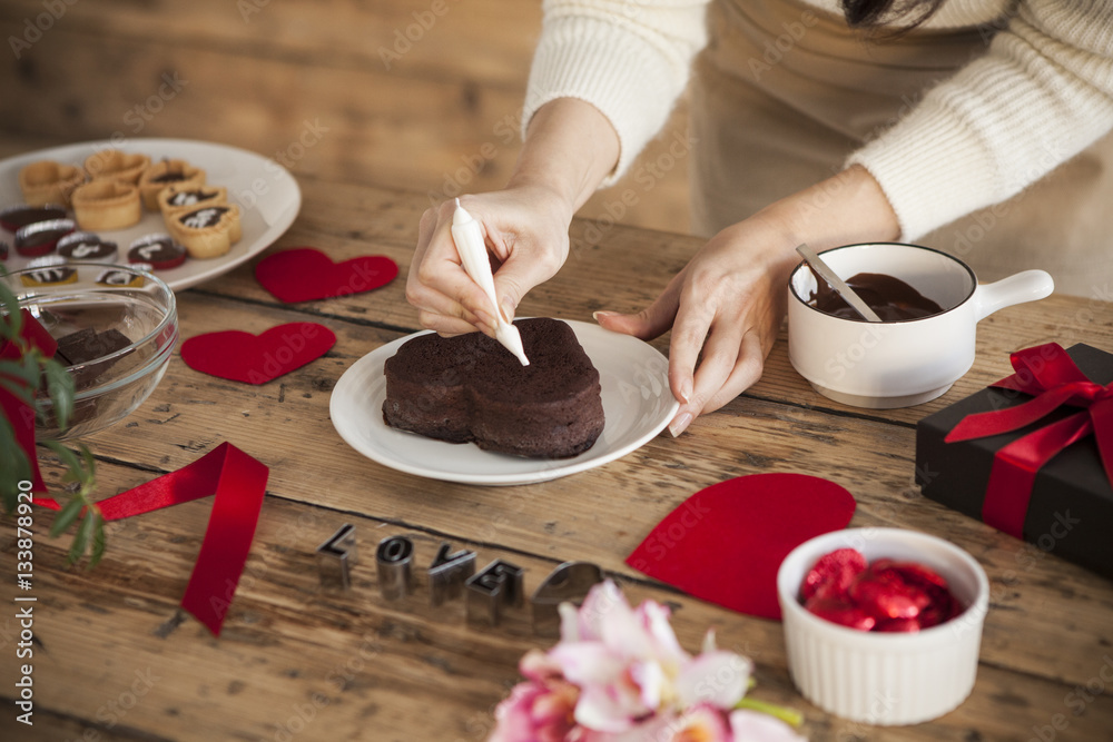 Women are decorating for chocolate cake