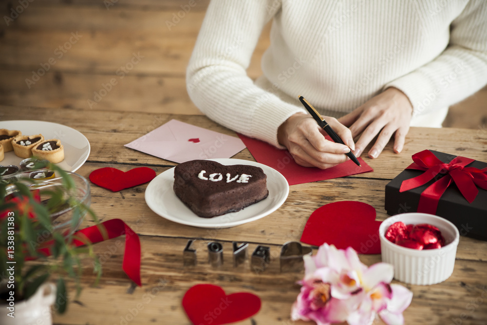 woman is writing a message of love