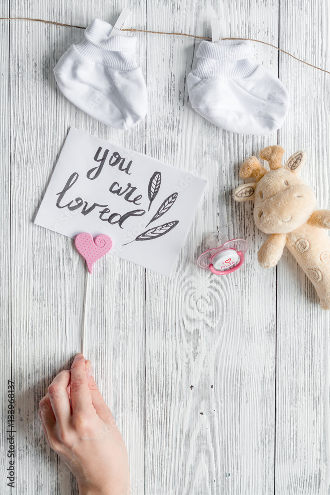 birth of child - baby shower concept on wooden background