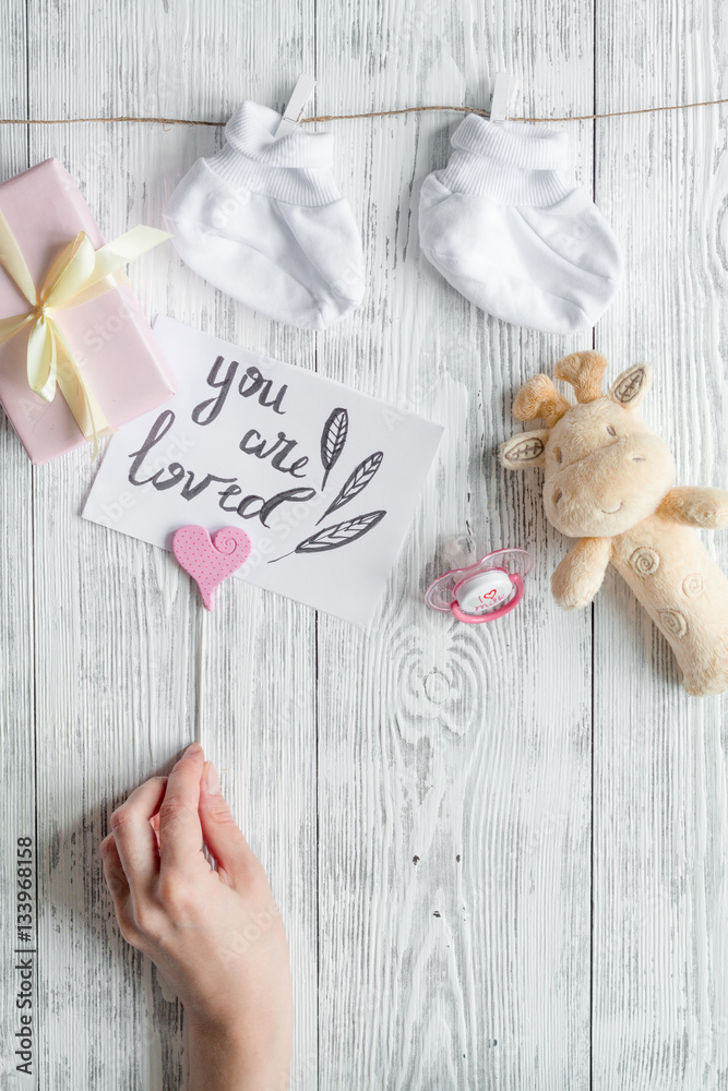 birth of child - baby shower concept on wooden background