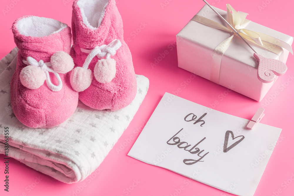 babys bootees and gift box on wooden background