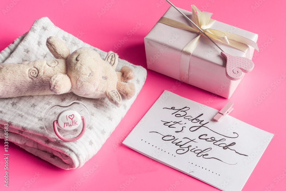 babys bootees and gift box on wooden background