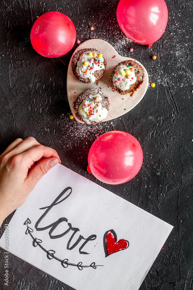 concept of Valentines Day cupcakes dark background top view