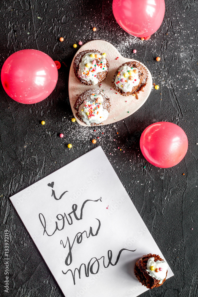 concept of Valentines Day cupcakes dark background top view