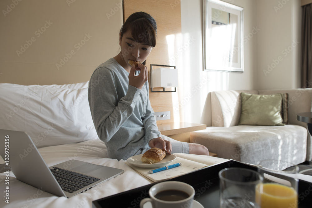 A young lady stayed at a hotel on a business trip and was eating breakfast