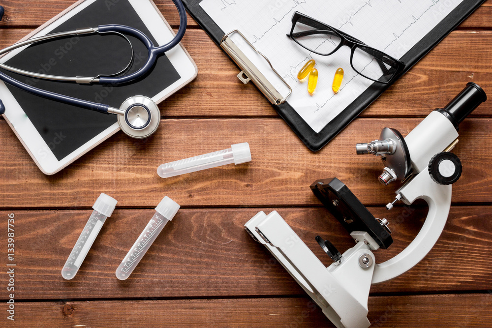 doctor workplace at wooden table in lab top view