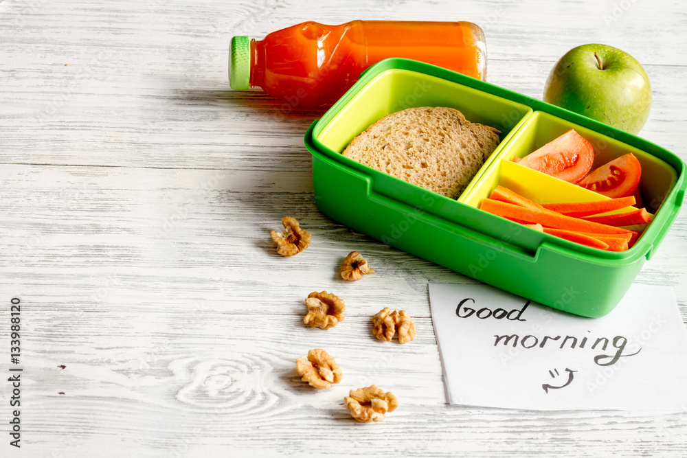 lunch box for kid with fresh vegetables on wooden background