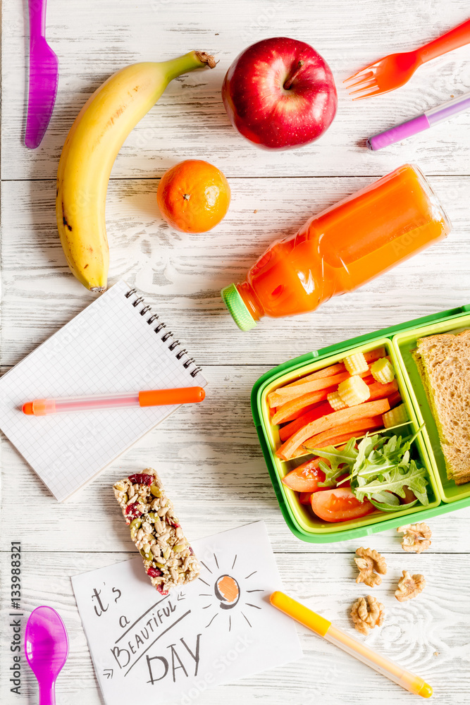 kid menu lunchbox for school top view on wooden background