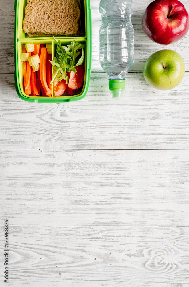 kid menu lunchbox for school top view on wooden background